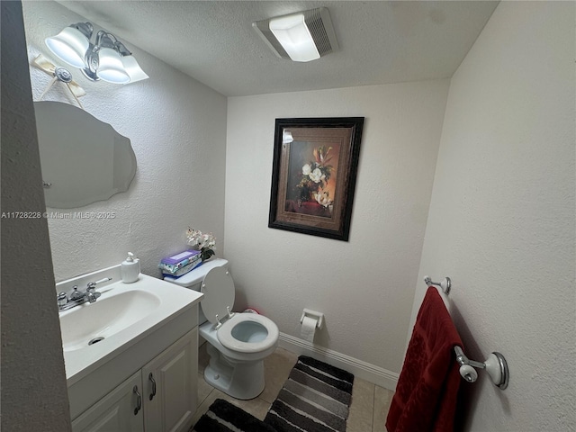 bathroom featuring a textured ceiling, tile patterned floors, vanity, and toilet