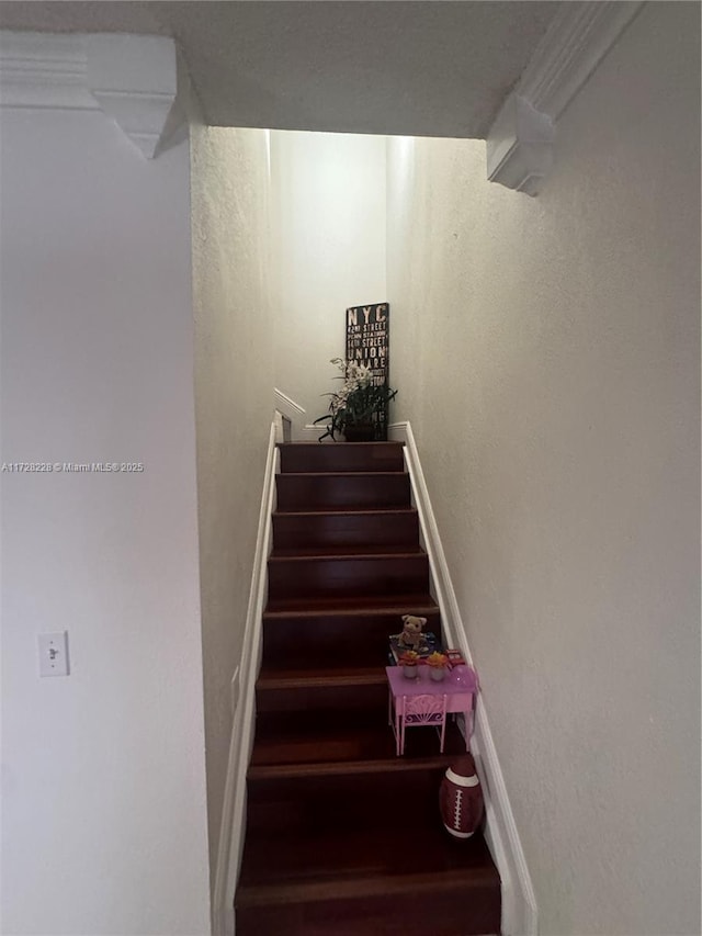 staircase with crown molding