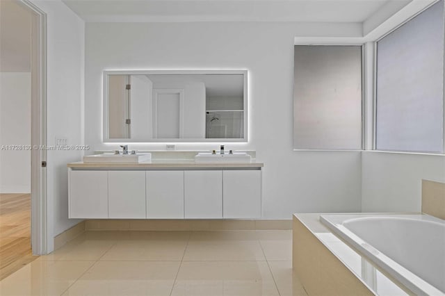 bathroom with tile patterned flooring, separate shower and tub, and vanity