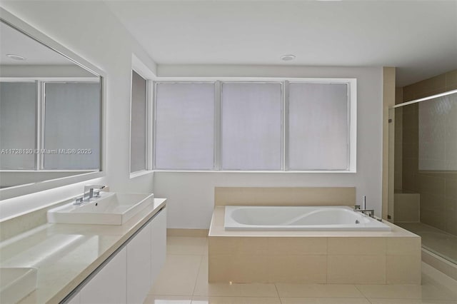 bathroom featuring vanity, tile patterned floors, and plus walk in shower