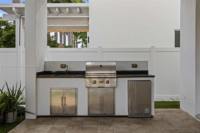 view of patio with sink, a grill, and area for grilling