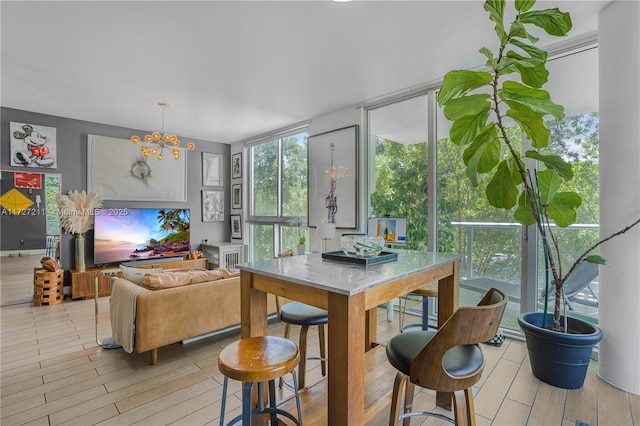 sunroom / solarium with an inviting chandelier