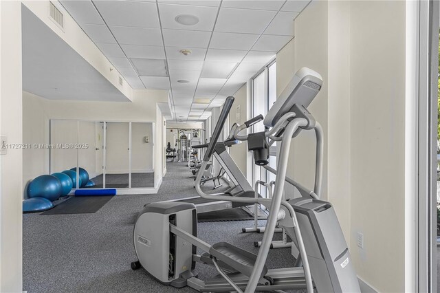 exercise room featuring a paneled ceiling