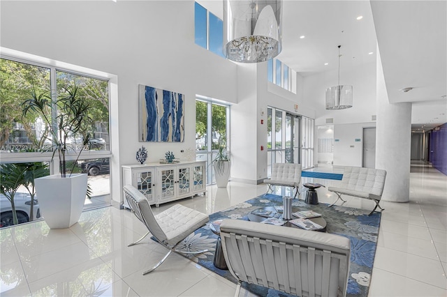 living room featuring a wealth of natural light, light tile patterned floors, and a towering ceiling