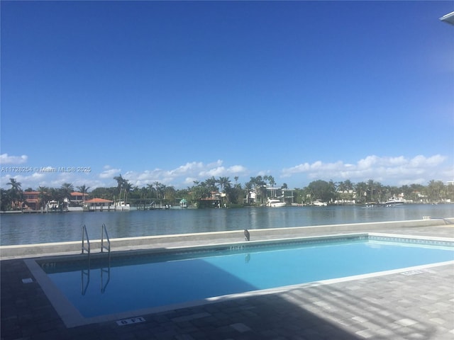 view of pool with a water view