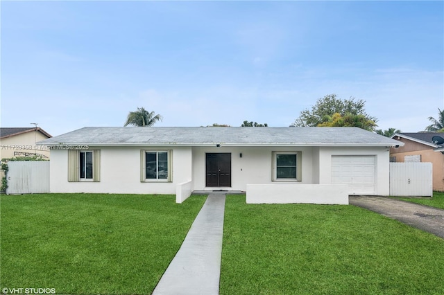 ranch-style home featuring a front yard and a garage