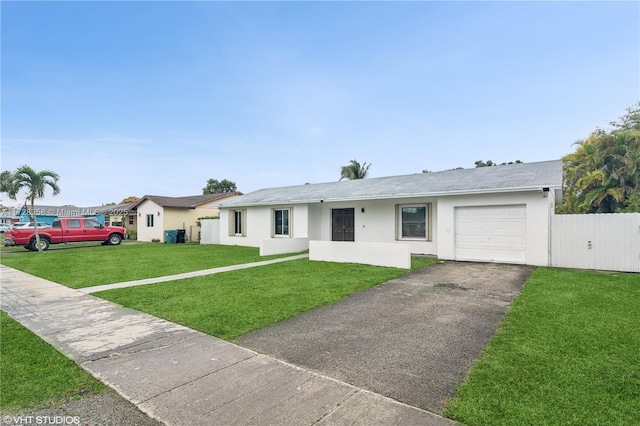 single story home featuring a front lawn and a garage