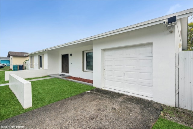 single story home with a front yard and a garage