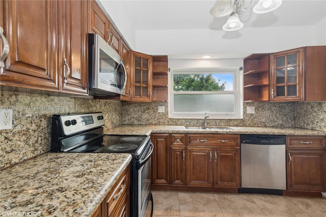 11030 SW 165th Ter, Miami, FL 33157 - kitchen featuring stainless steel appliances, a sink, open shelves, and light stone counters