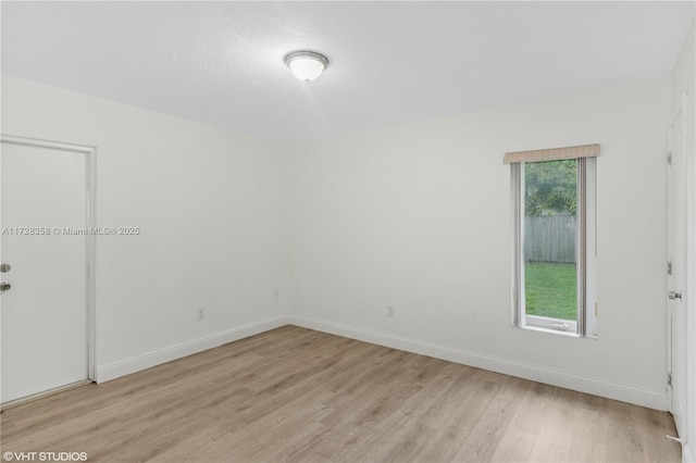 spare room with light hardwood / wood-style floors