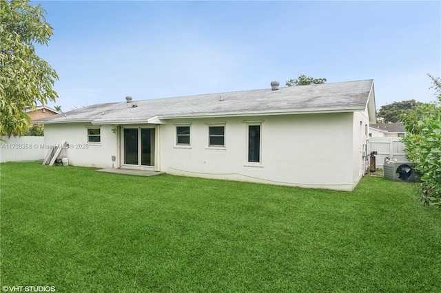 rear view of house with a lawn