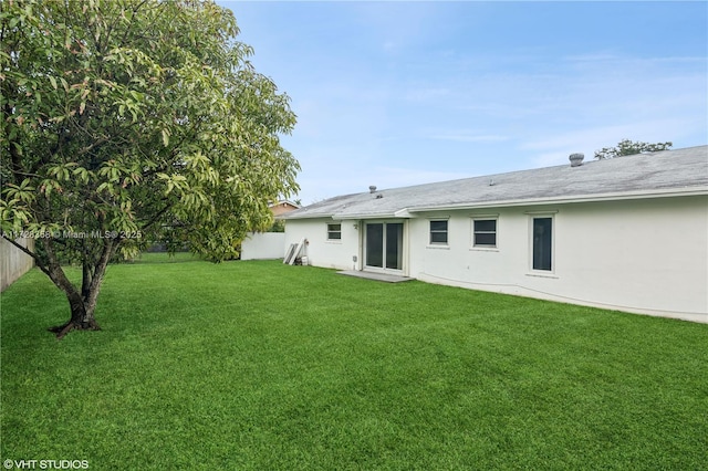 rear view of property with a lawn