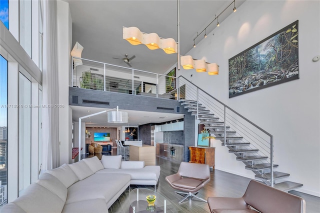 living room featuring hardwood / wood-style floors and a towering ceiling