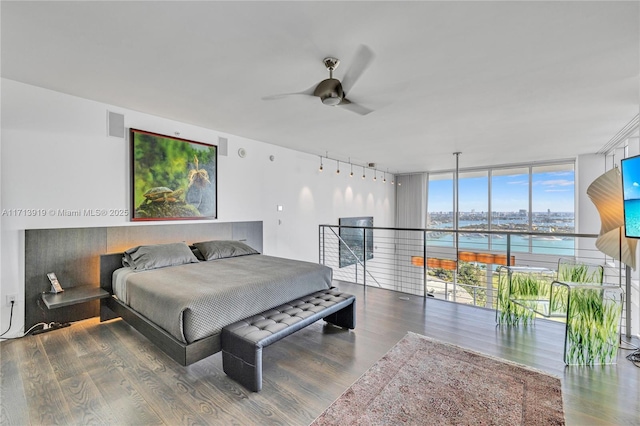 bedroom featuring ceiling fan, hardwood / wood-style floors, and a wall of windows