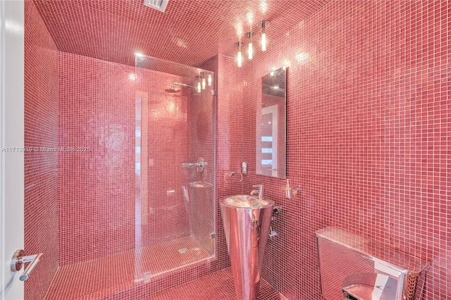 bathroom with tile walls and tiled shower