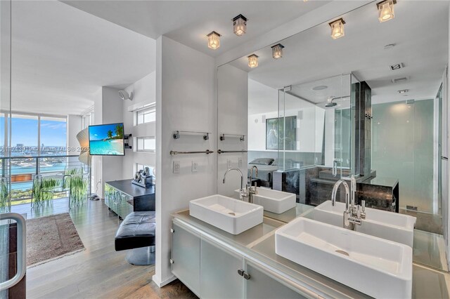 bathroom featuring hardwood / wood-style floors, a wall of windows, and vanity