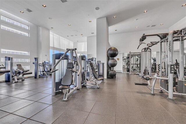 exercise room featuring a high ceiling