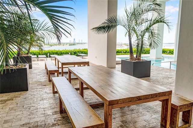 view of patio with a water view