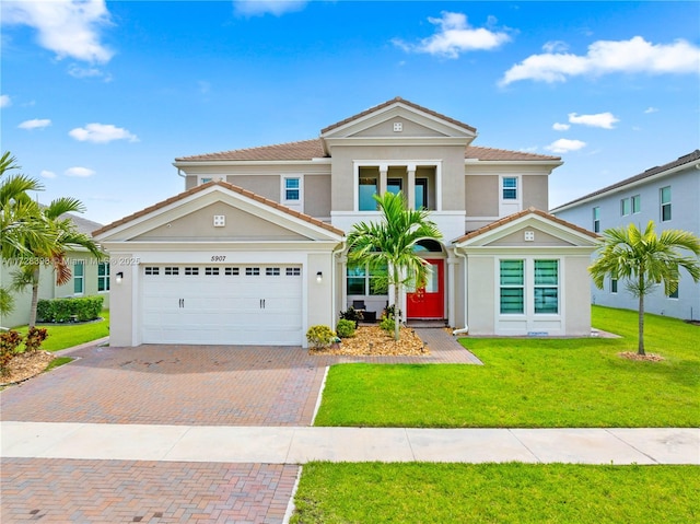 view of front facade with a garage and a front lawn