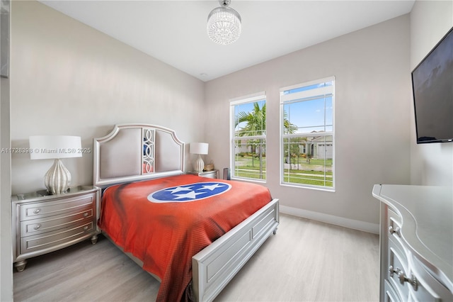 bedroom with light hardwood / wood-style flooring and lofted ceiling