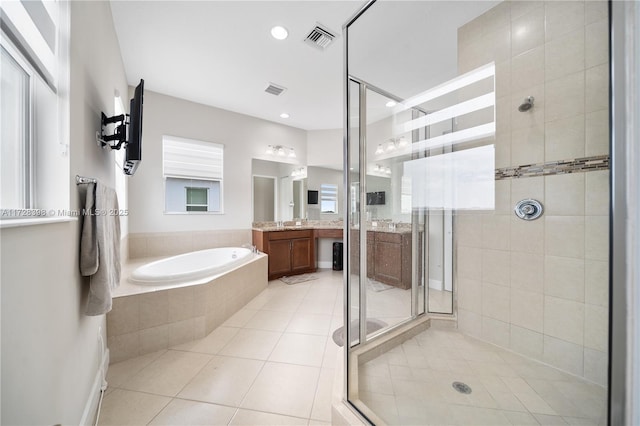 bathroom featuring tile patterned flooring, shower with separate bathtub, and vanity