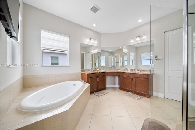 bathroom with vanity, tile patterned floors, and plus walk in shower