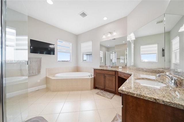 bathroom with tile patterned floors, vanity, and plus walk in shower