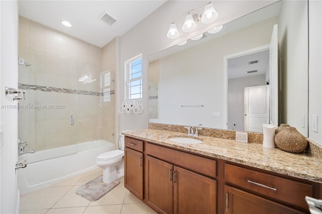 full bathroom featuring tile patterned floors, toilet, vanity, and tiled shower / bath