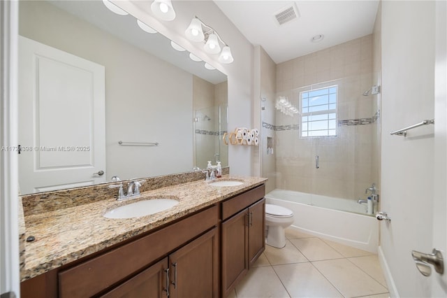 full bathroom with toilet, combined bath / shower with glass door, tile patterned flooring, and vanity