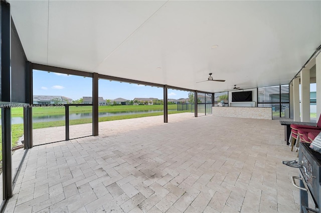 view of patio / terrace with ceiling fan and a water view