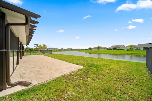 view of yard featuring a patio area and a water view