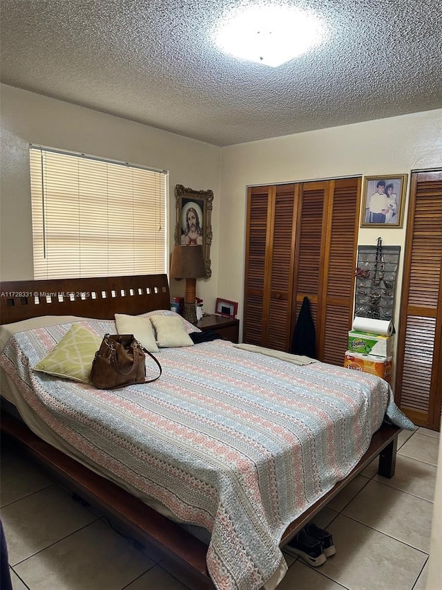 tiled bedroom with a textured ceiling