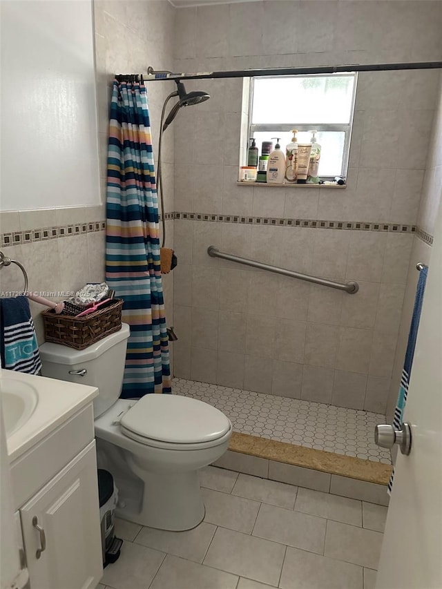 bathroom featuring tile patterned floors, vanity, toilet, and walk in shower