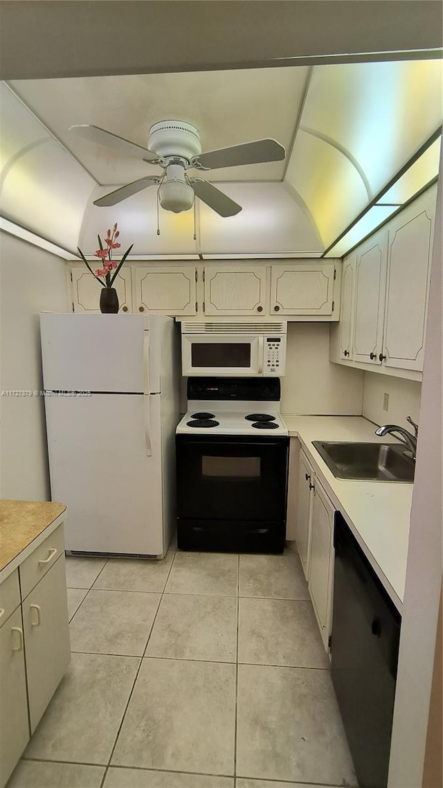 kitchen with ceiling fan, sink, white appliances, and light tile patterned flooring