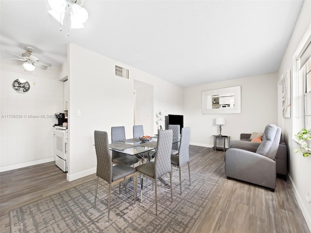 dining room with ceiling fan and hardwood / wood-style floors