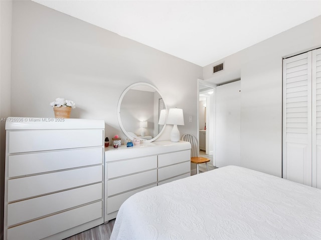 bedroom featuring a closet and hardwood / wood-style flooring