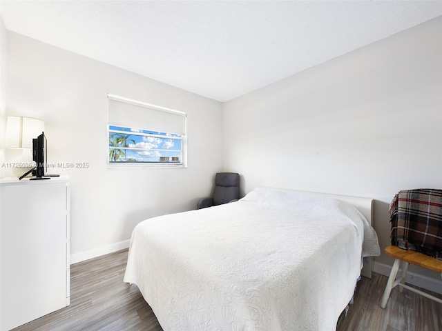 bedroom with hardwood / wood-style flooring