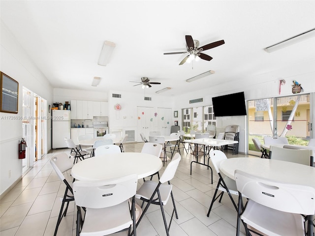 tiled dining room featuring ceiling fan