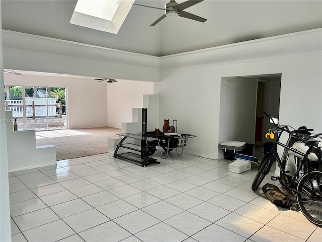 carpeted living room with ceiling fan, crown molding, high vaulted ceiling, and a skylight