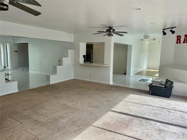 unfurnished living room with ceiling fan and light tile patterned flooring