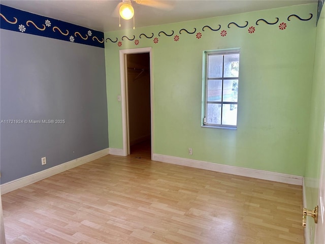 empty room featuring ceiling fan and light hardwood / wood-style flooring