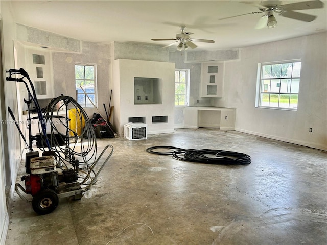 interior space with ceiling fan