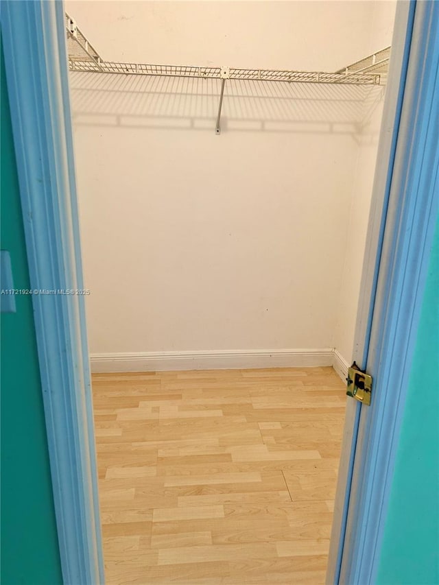 spacious closet with light hardwood / wood-style floors