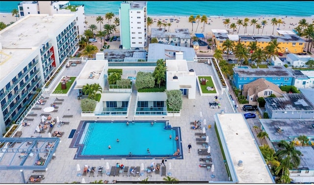 aerial view with a water view and a beach view