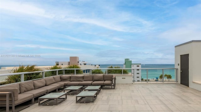 view of patio with a water view, an outdoor living space, and a balcony