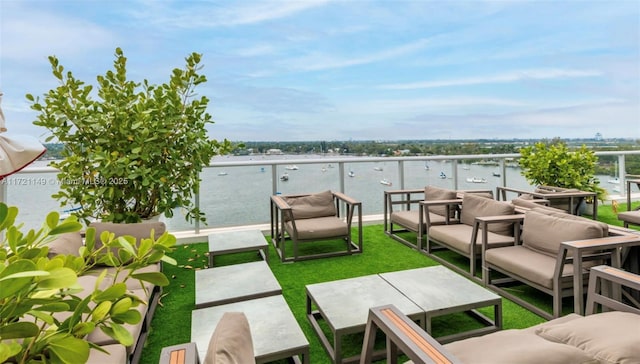 view of patio / terrace with a balcony, outdoor lounge area, and a water view