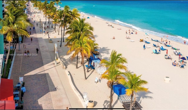 birds eye view of property featuring a view of the beach and a water view