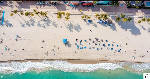 birds eye view of property featuring a water view and a view of the beach