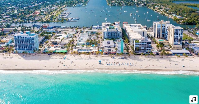 bird's eye view featuring a view of the beach and a water view