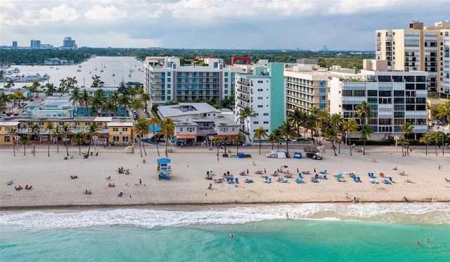 birds eye view of property featuring a water view and a view of the beach